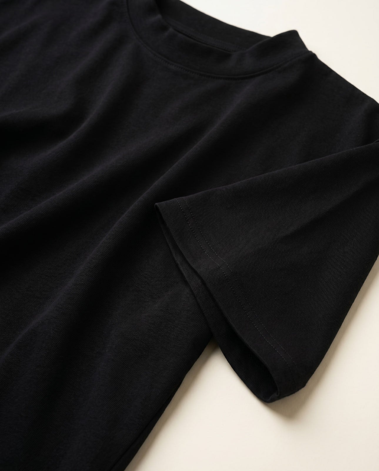Macro close-up of the heavyweight black cotton jersey texture