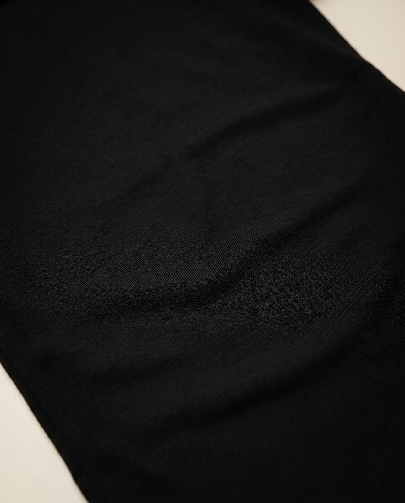 Joubify black long sleeve top in smooth matte stretch jersey with fine ruching detail