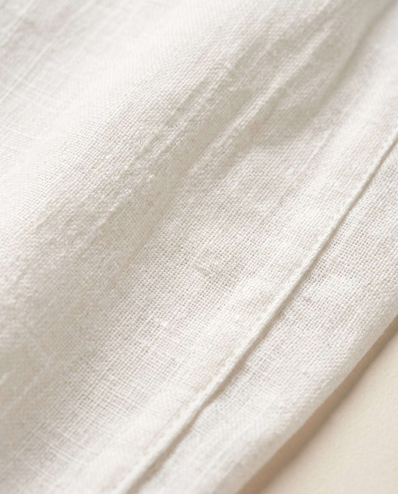 Macro close-up of the white linen weave texture