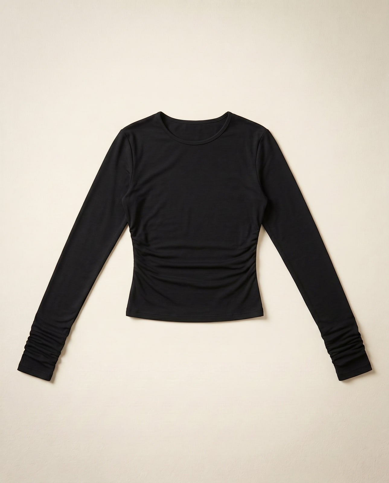 Joubify black long sleeve top in matte stretch jersey with a round neck and ruched waist detail