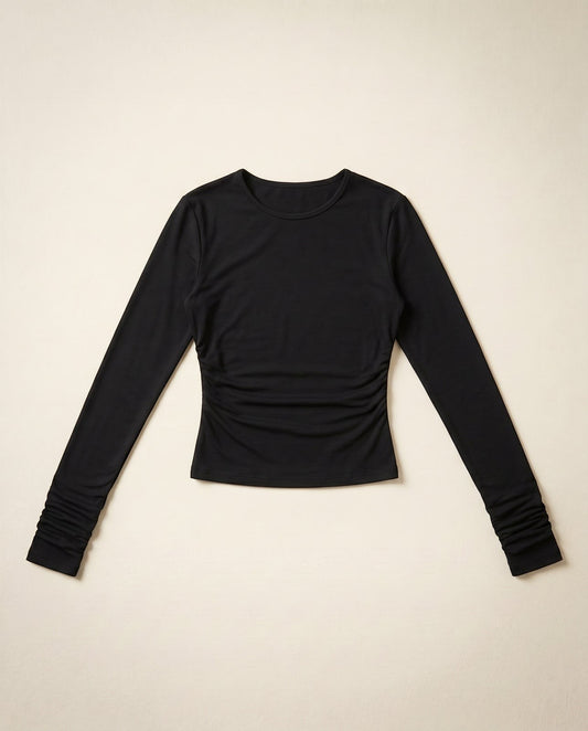 Joubify black long sleeve top in matte stretch jersey with a round neck and ruched waist detail