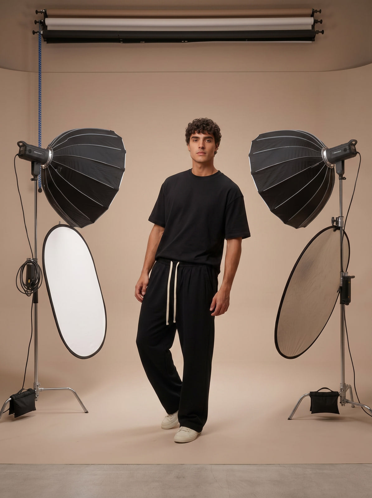 Joubie in a relaxed lean pose in the Joubify Branding Room wearing the black wide-leg sweatpants