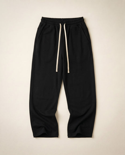 Black wide-leg sweatpants flat lay showing French terry and cream drawstring